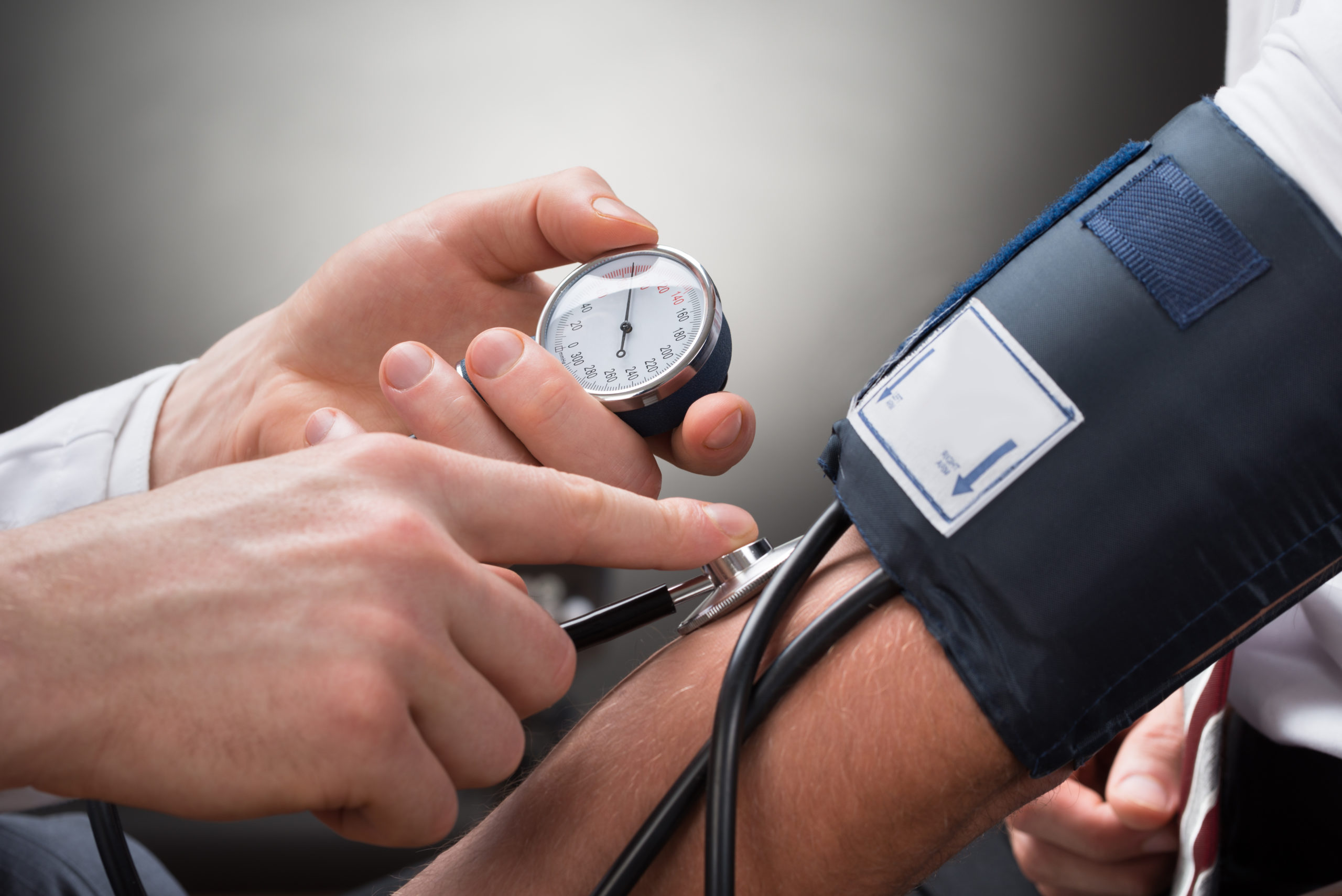 Person having blood pressure checked by a health professional