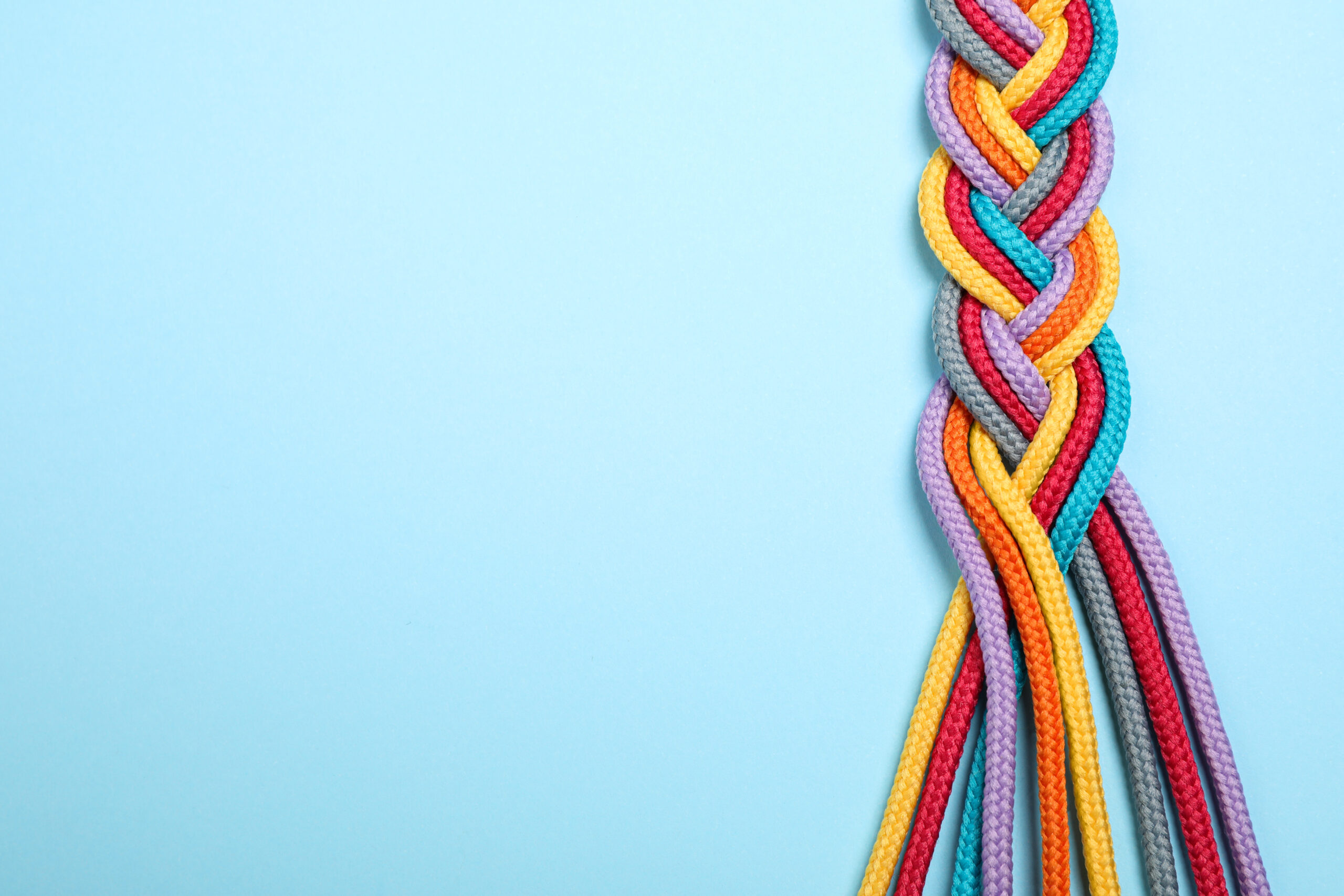 Multicoloured rope plated on a blue background