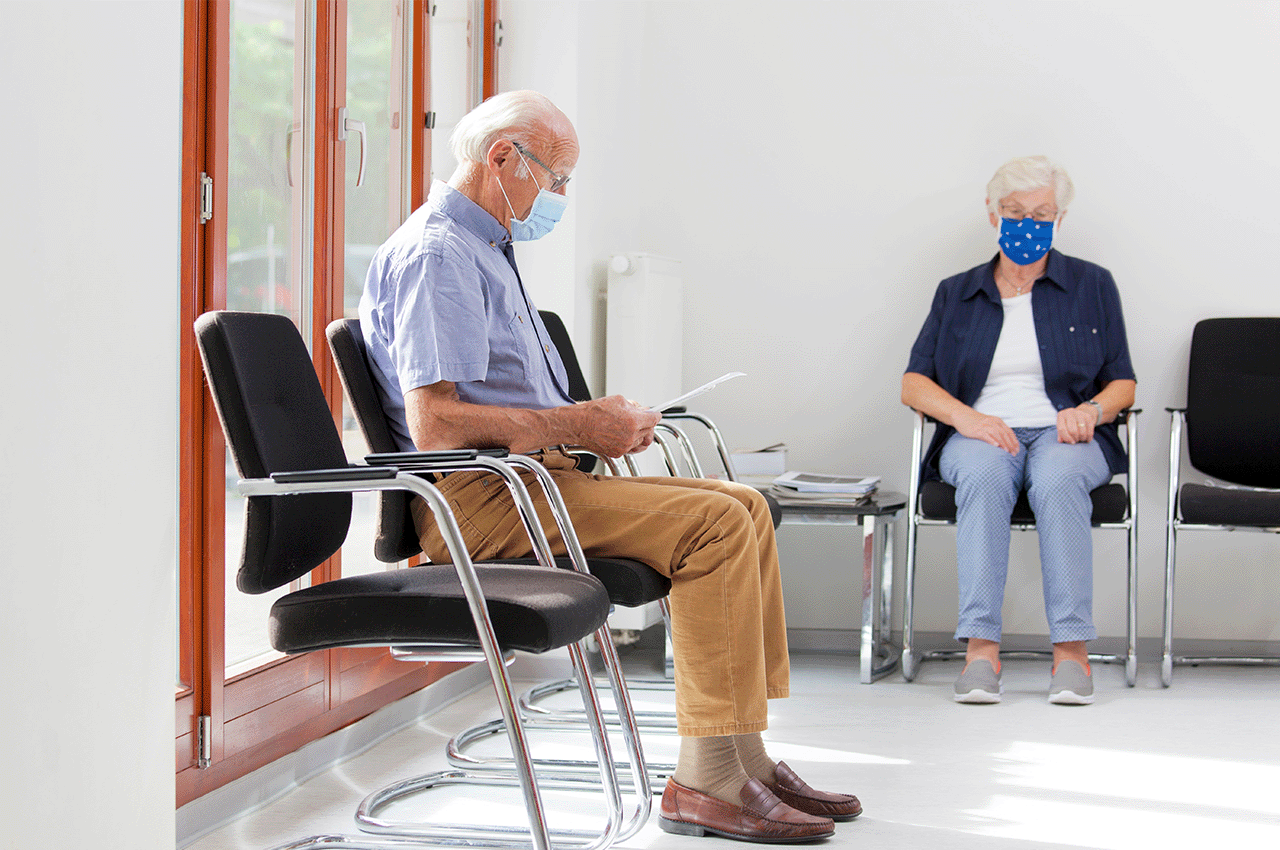 Two people sitting in clinical waiting room