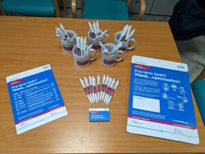 Merchandise provided by the patient safety programme manager on a visit to Liverpool Women's Hospital. Includes MatNeoSIP branded pens, mugs, posters and quick reference cards.
