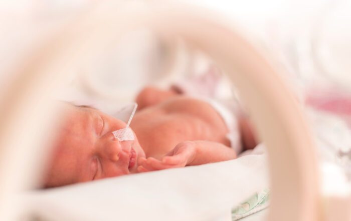 Premature newborn baby girl in the hospital incubator.
